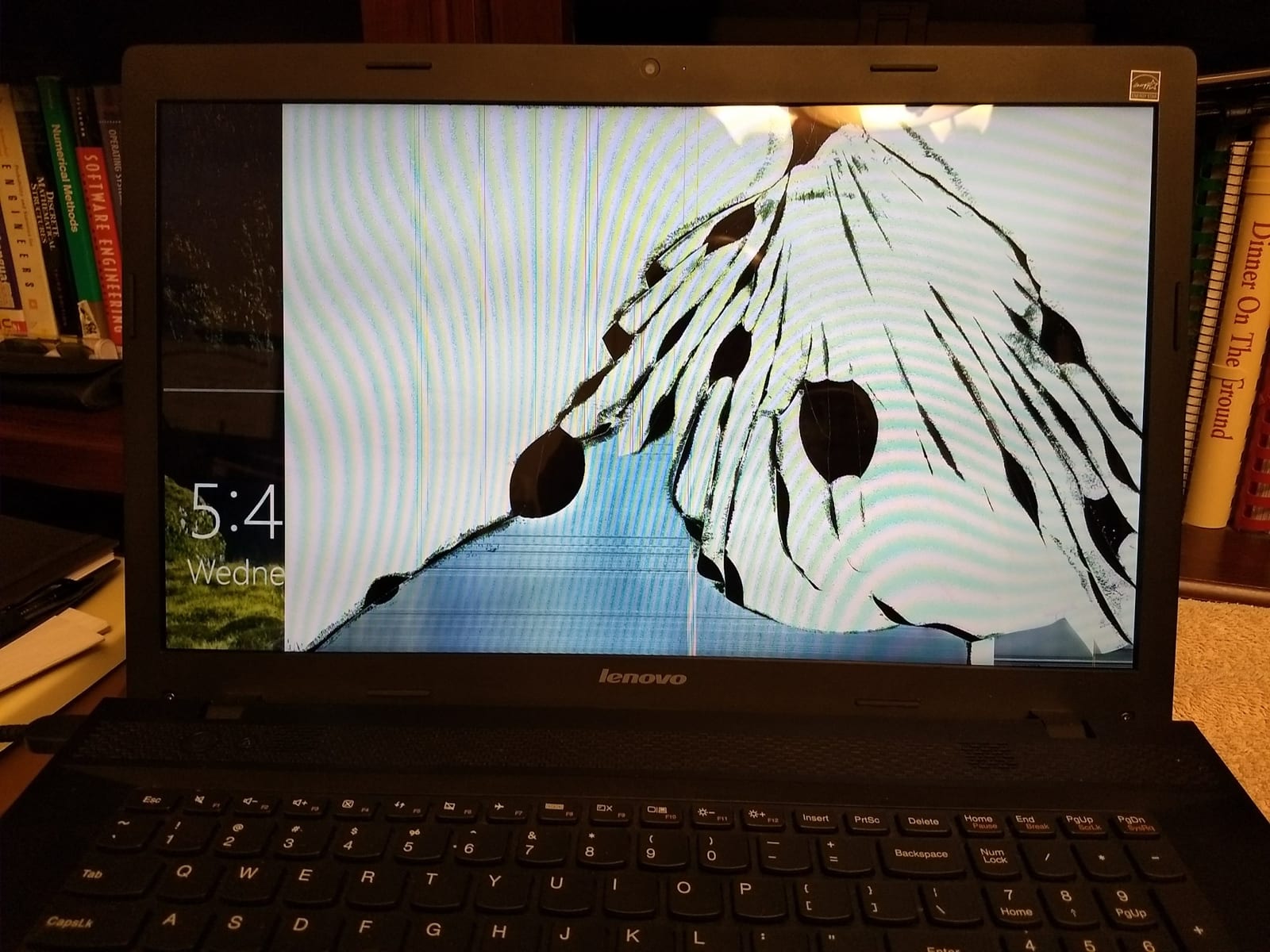 A laptop with a cracked display waiting for a screen replacement